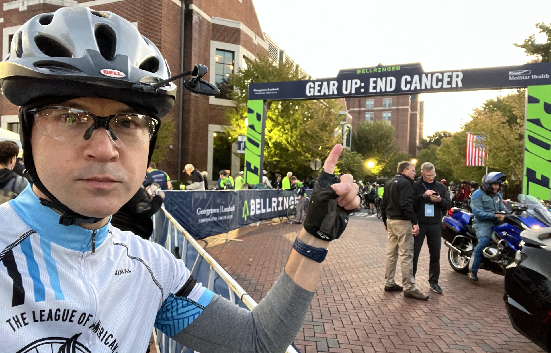 BellRinger rider posing with the start line of the ride