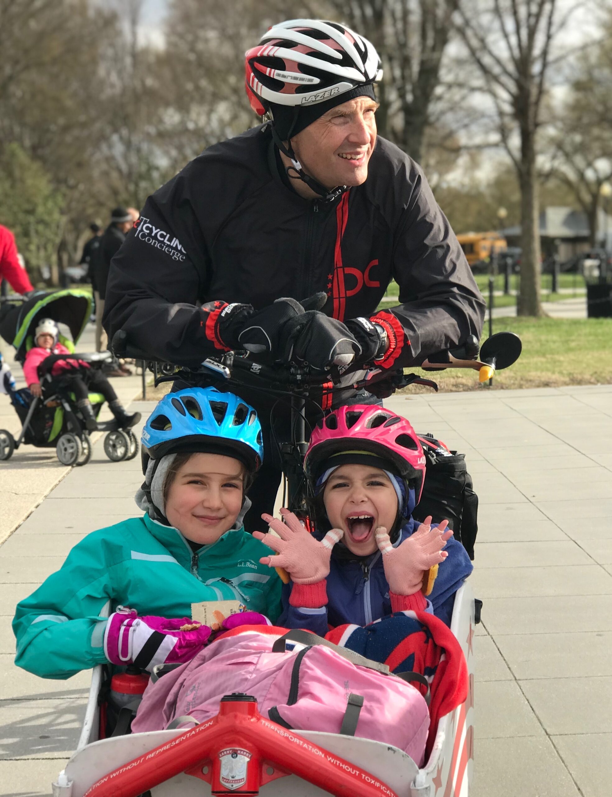 BellRinger rider and his daughters on a sidewalk