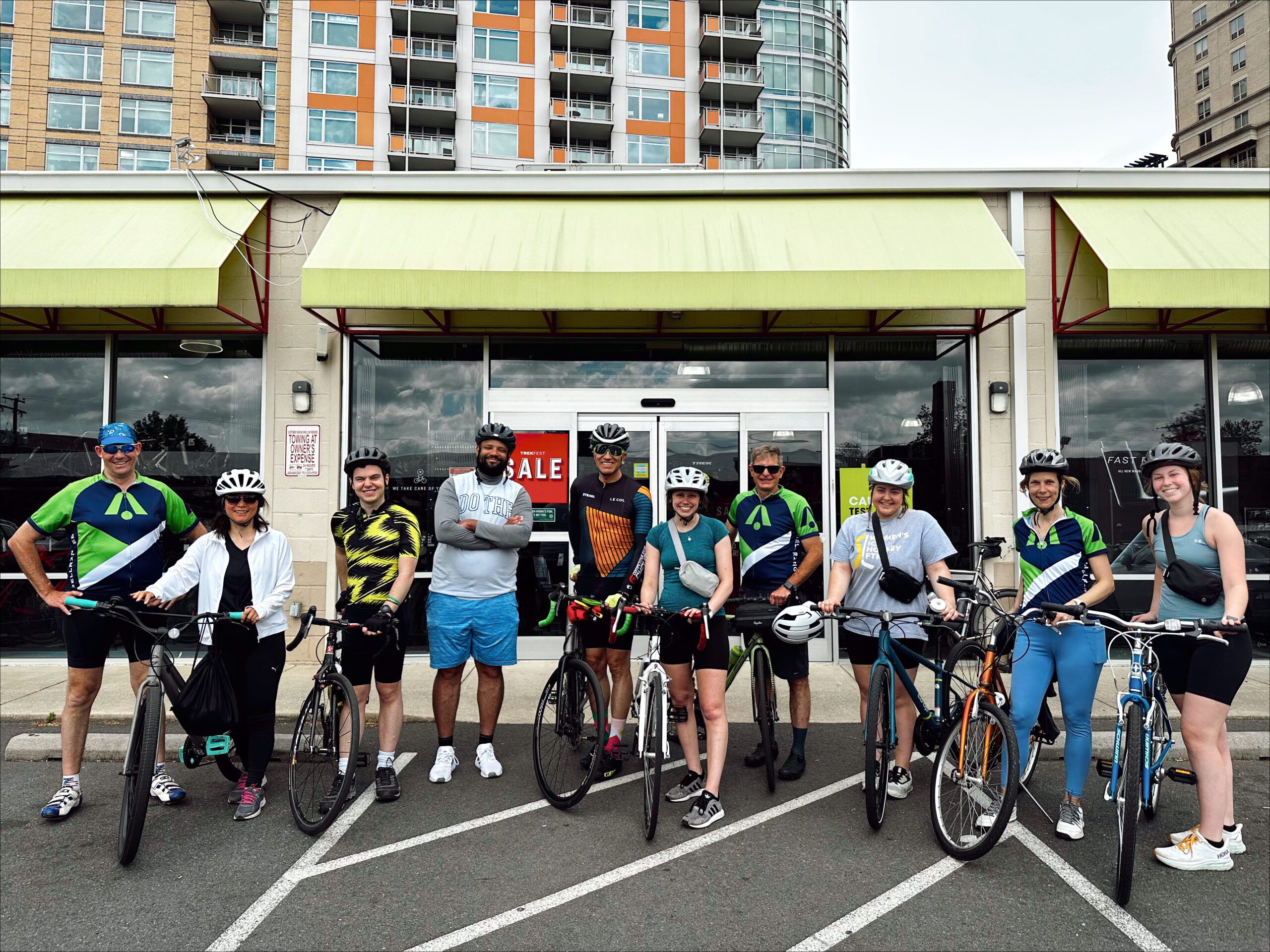 Group of BellRinger rides posing next to their bikes in front of a store