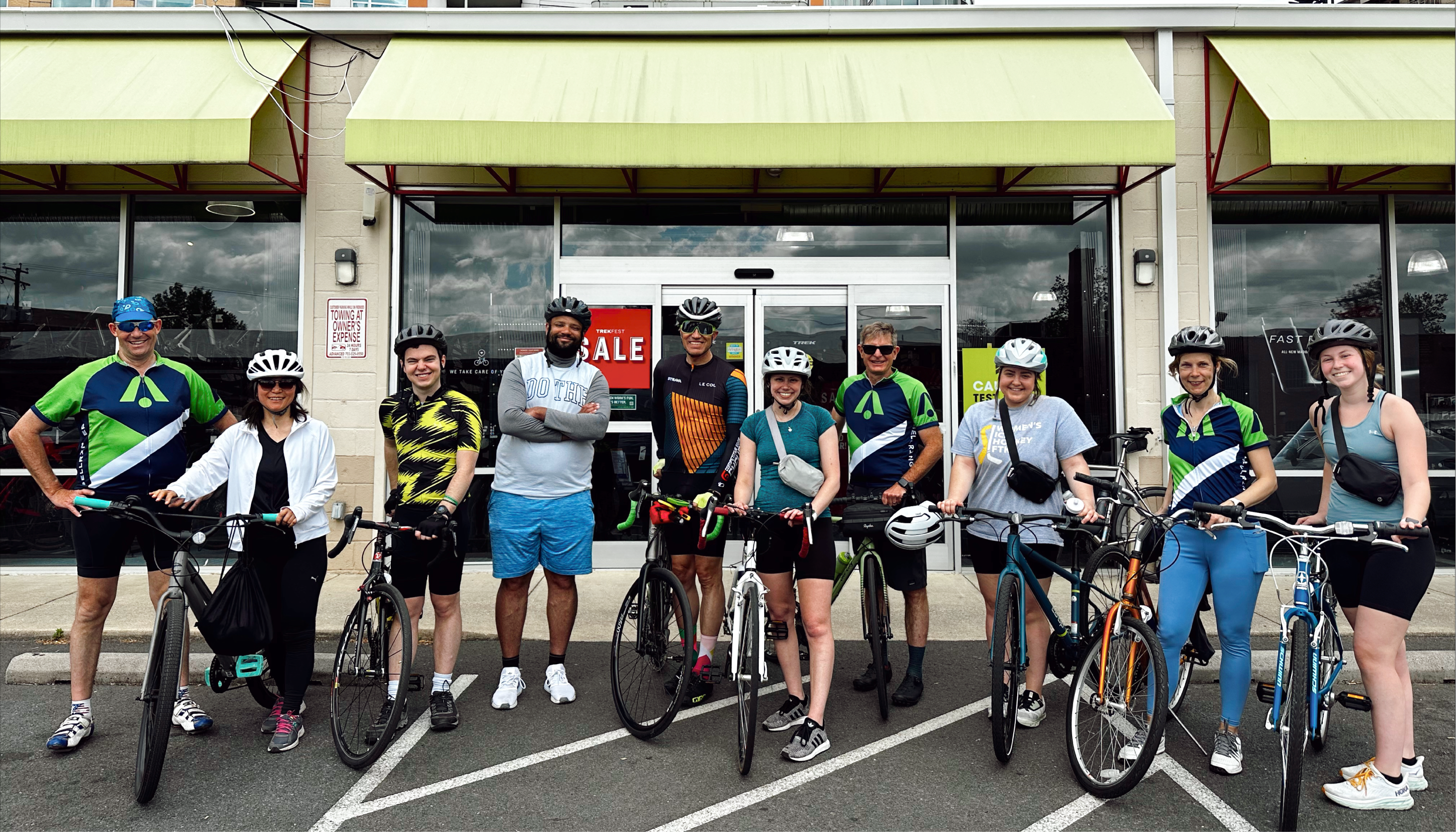 BellRinger riders standing next to their bikes in front of a store